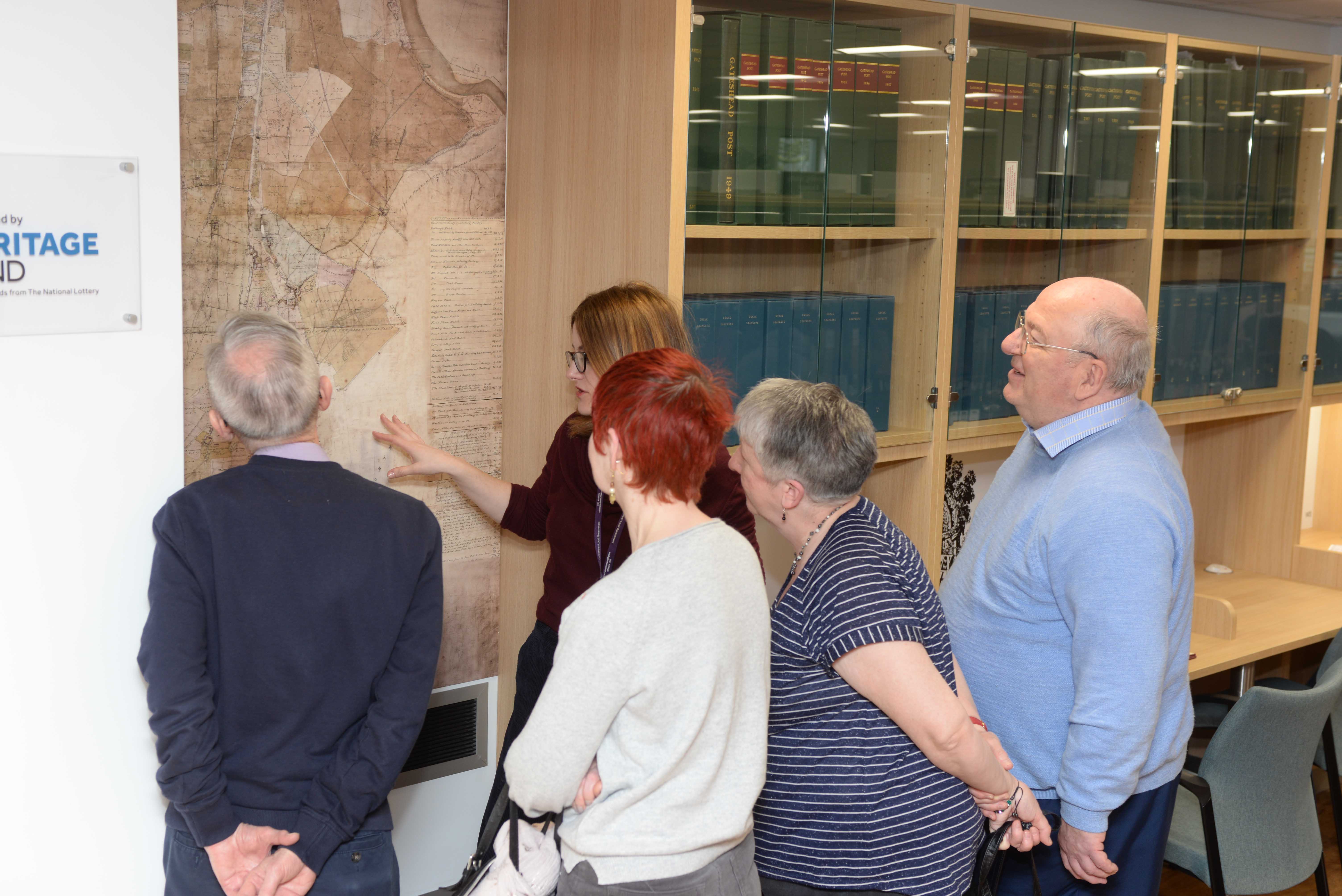 People viewing a local heritage map at Gateshead Archive 