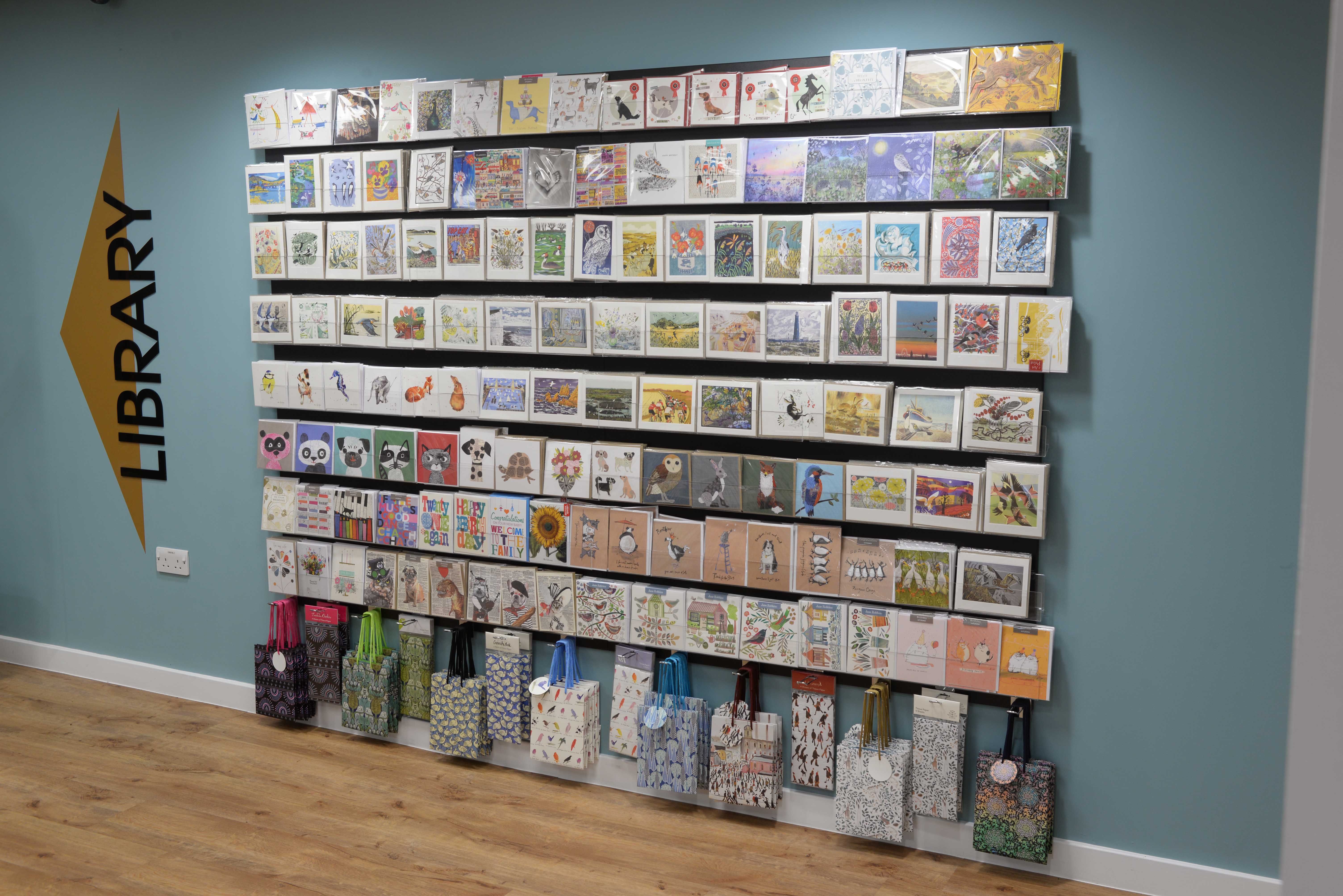 Wall-mounted display unit for cards and gift wrap in the library shop
