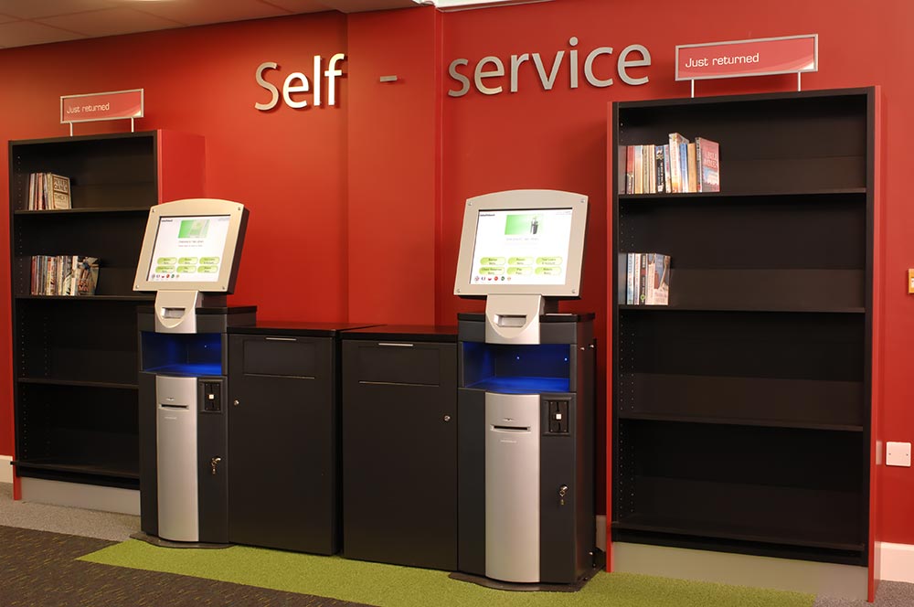Self-service area highlighted with accent colour on walls and carpet, Yate Library