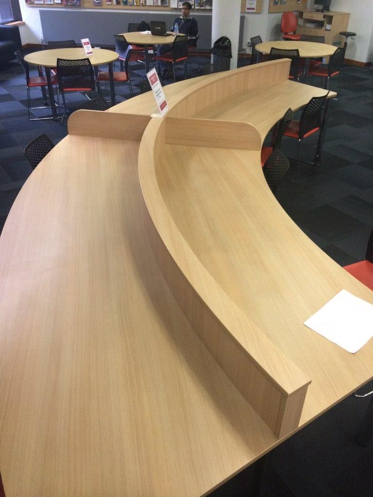 Curved IT desksCurved desk with central divider to define shared space