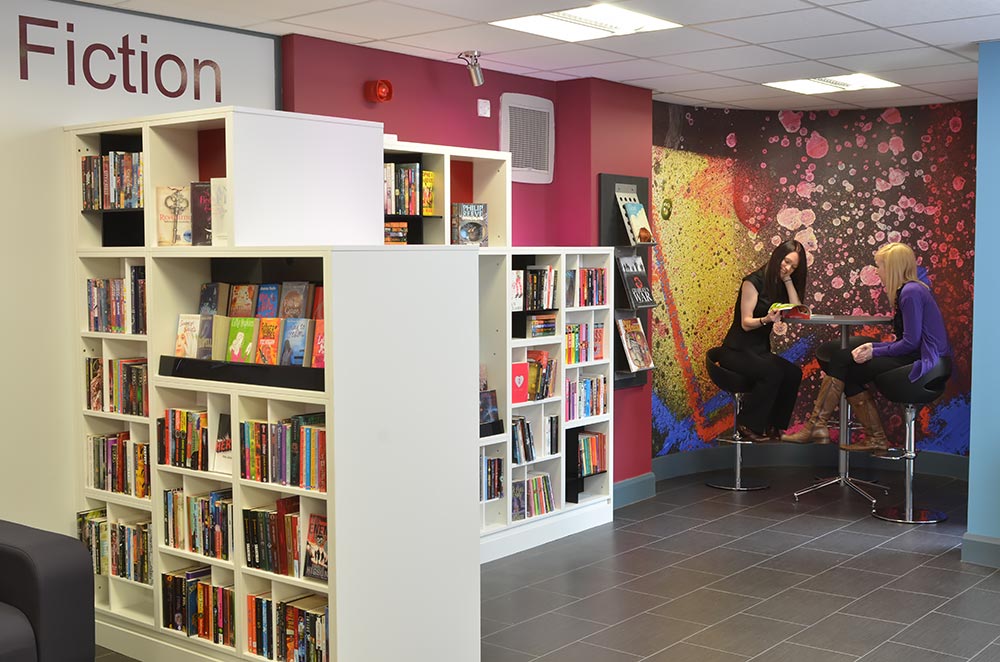 Graffiti wall graphic and cube shelving in teensâ€™ area, Gateshead Central Library