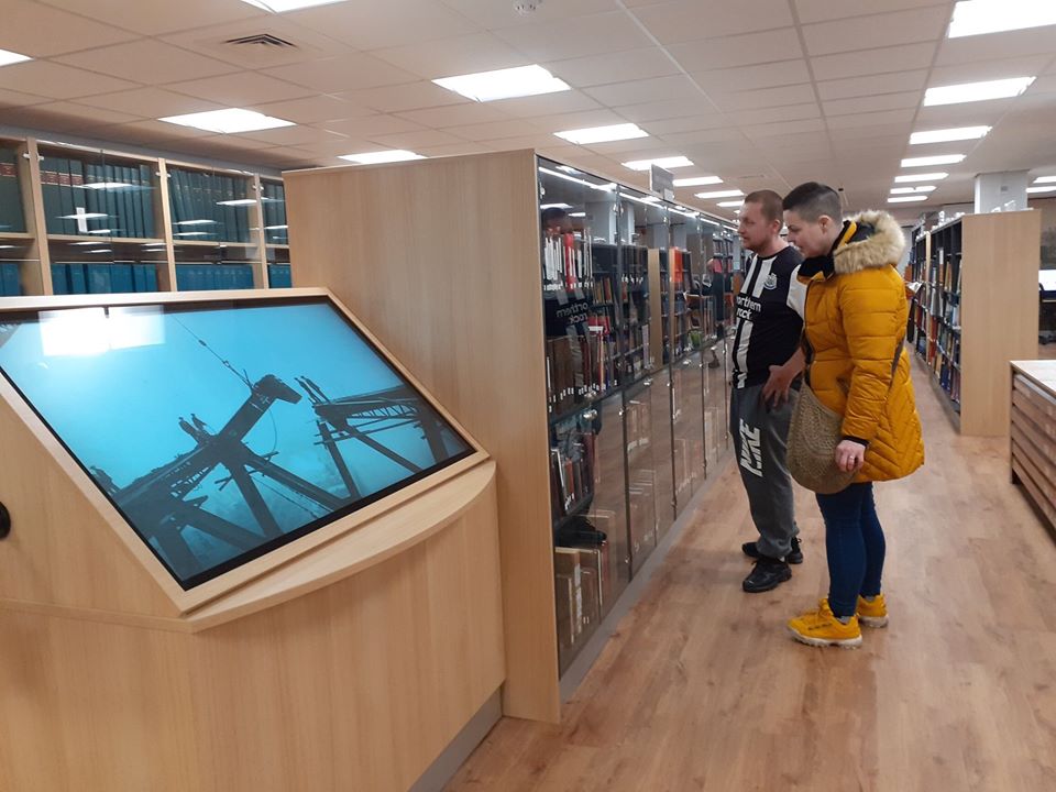 Interactive screen and couple browsing lockable glazed cabinets