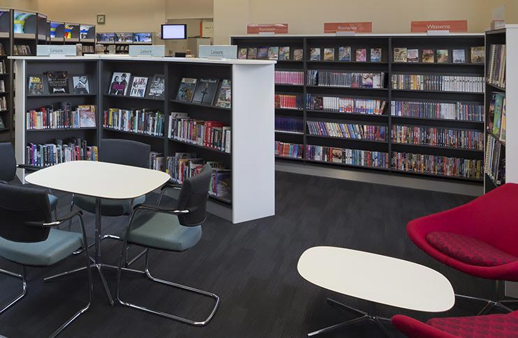Desks and chairs in easy reach of books, West Bridgford Library