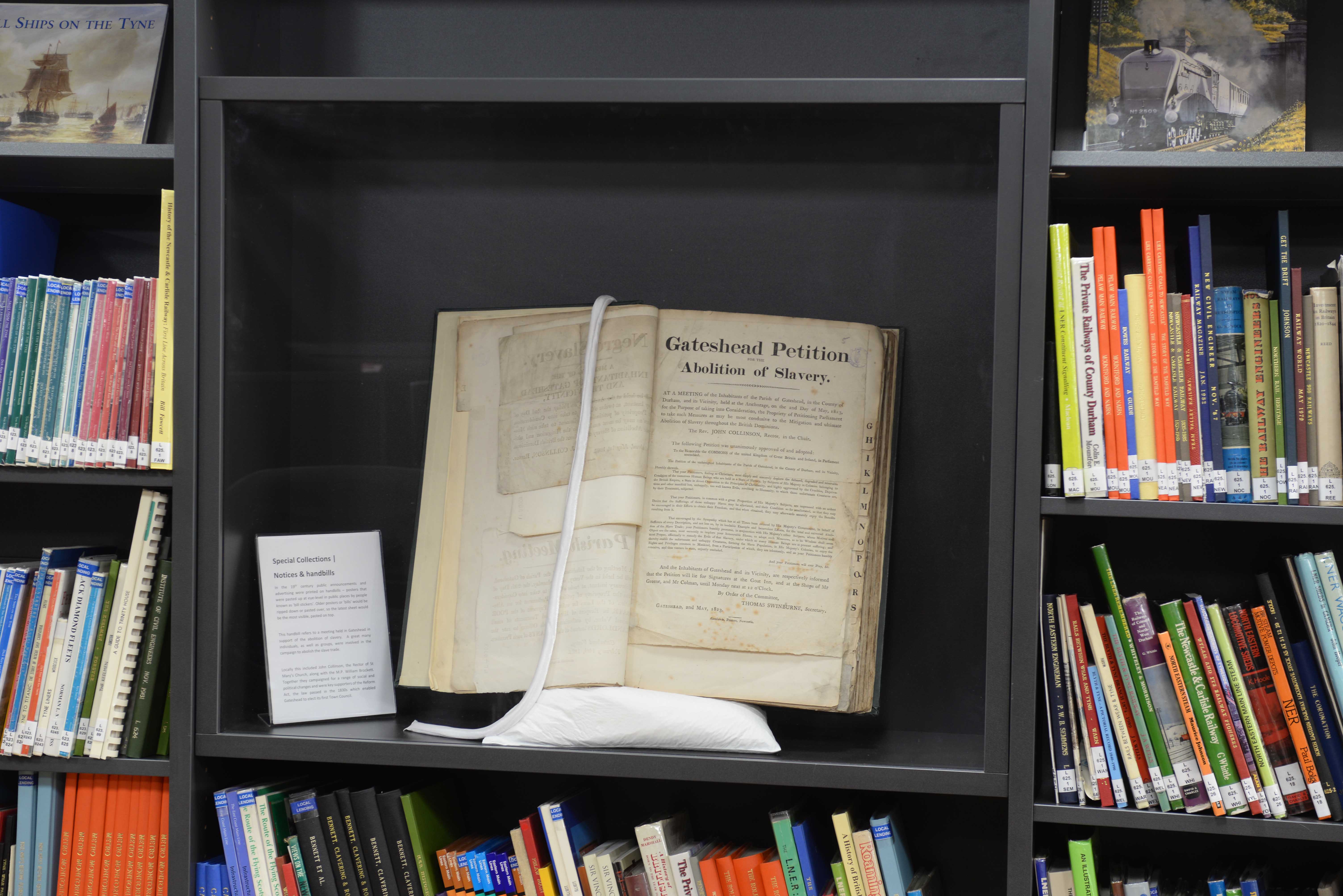 One of our unique museum boxes fixed into a standard bookcase, displaying Gateshead Petition for the Abolition of Slavery