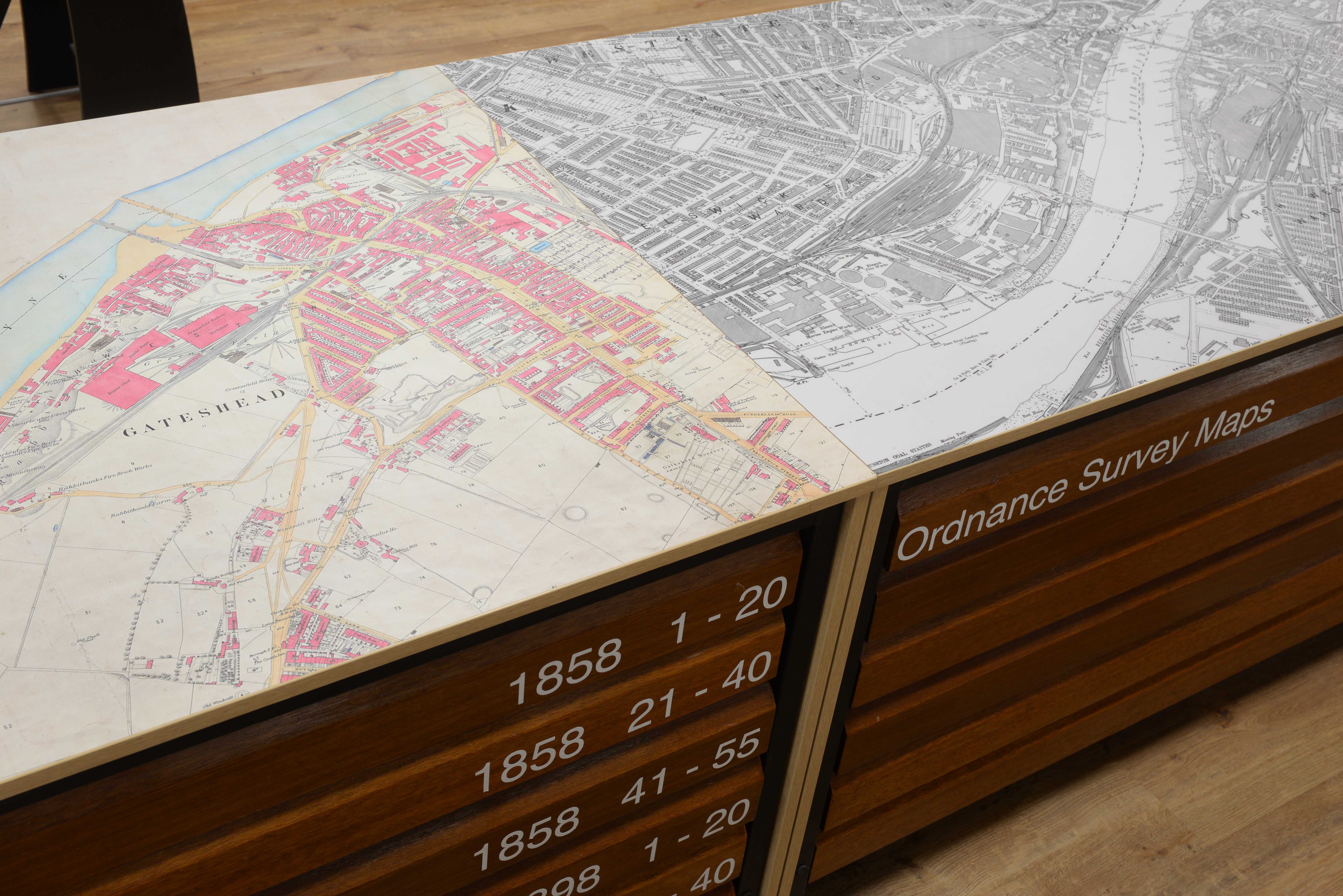 Prints of most frequently used maps decorate tops of map cabinets