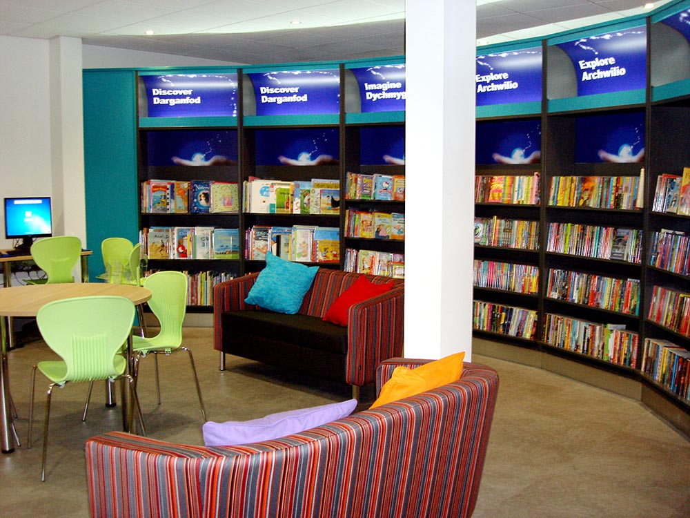 Colourful cushions on sofas in childrenâ€™s area, Bridgend Library